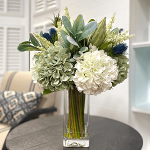 Creative Displays Assorted hydrangea, lamb’s ear and protea arrangement in clear glass