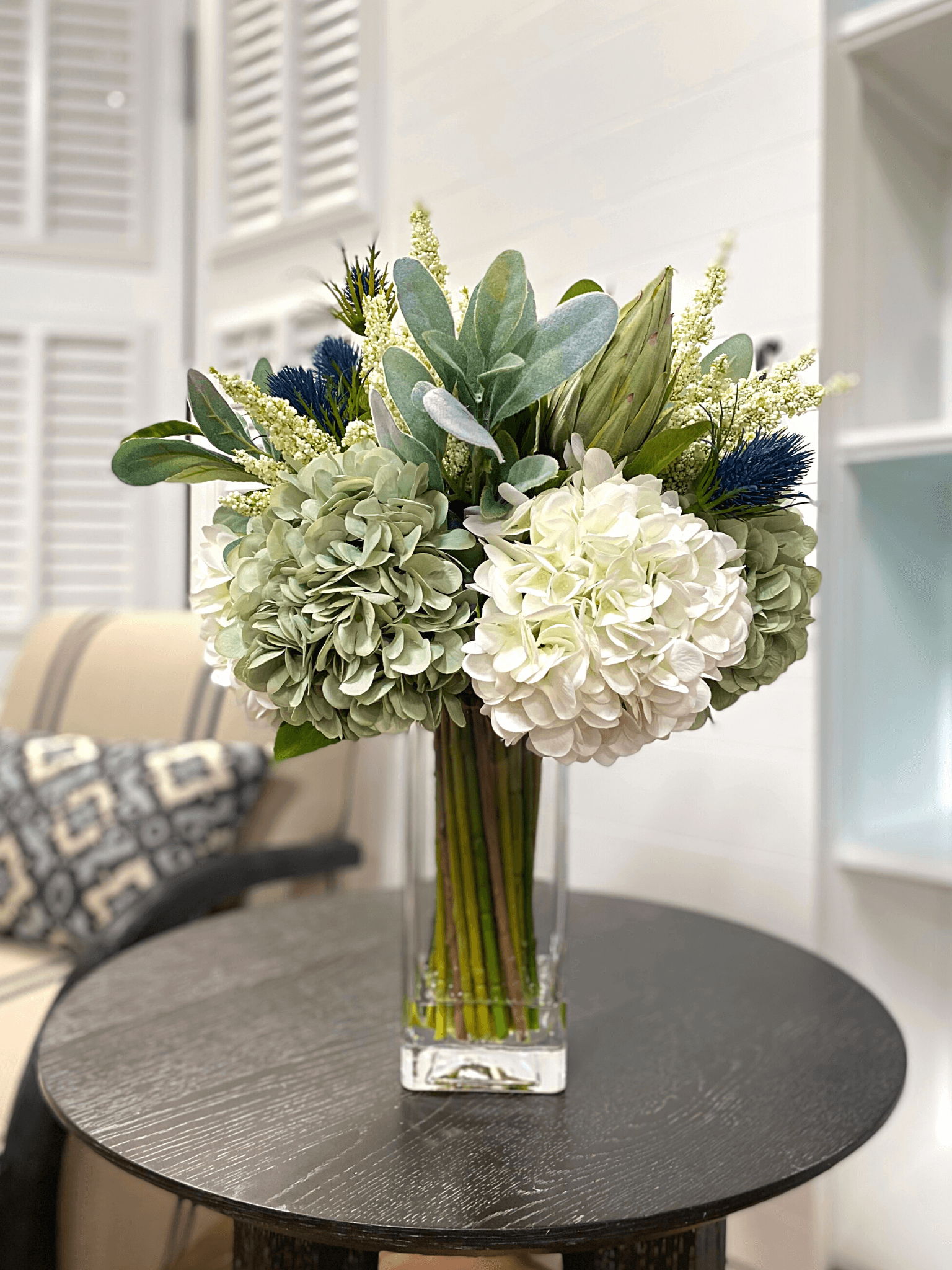 Creative Displays Assorted hydrangea, lamb’s ear and protea arrangement in clear glass
