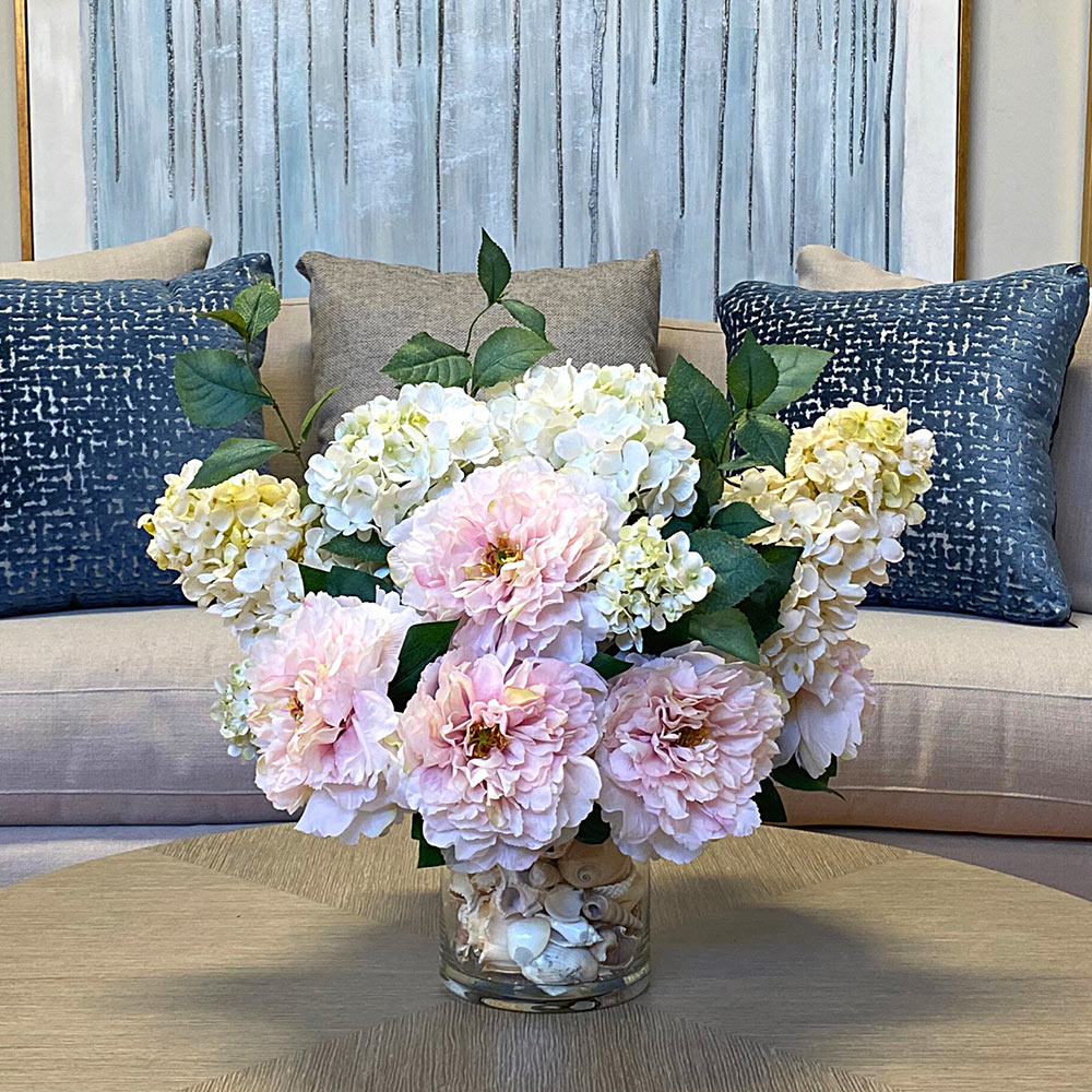 Creative Displays Floral Arrangement with Peonies and Hydrangea in Clear Glass Vase with Seashells