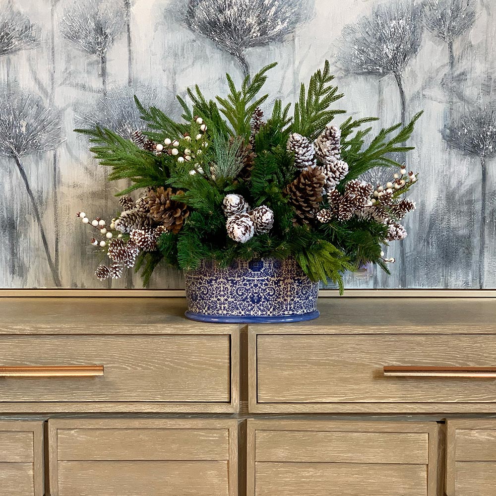 Creative Displays Holiday Arrangement with Assorted Pinecones and Evergreen in Blue/White Ceramic Oval Vase