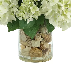 Hydrangea Floral Arrangement in a Clear Glass Vase with Seashells