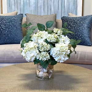 Hydrangea Floral Arrangement in a Clear Glass Vase with Seashells